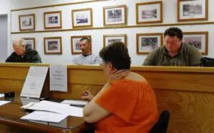 Nelsonville board (L to R) Trustee Ande Merante, Mayor Tom Corless, Trustee Peter Tomann. Foreground: Village Clerk Pauline Minners