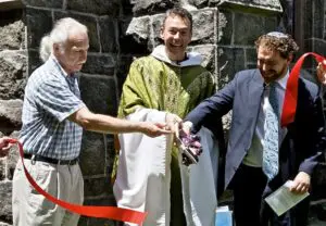 Ed Kamper, Fr. McShane and Rabbi Mike cut the ribbon
