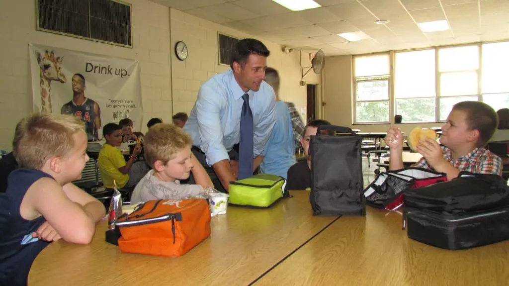 Principal Harrington with students
