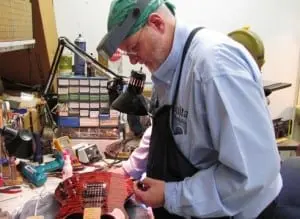Cummings prepares a guitar for shipping