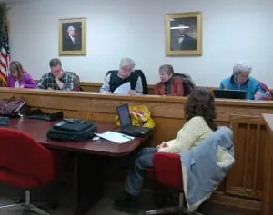 Before their vote, HDRB members finalize their resolution on demolition of the old hospital; left to right: Kathleen Foley, Peter Downey, Al Zgolinski, Carolyn Bachan, Marie Early. Photo by L.S. Armstrong