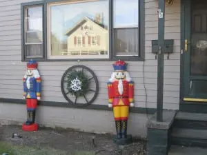 Two large nutcracker figures greet the children outside of the house. Photo by A. Rooney