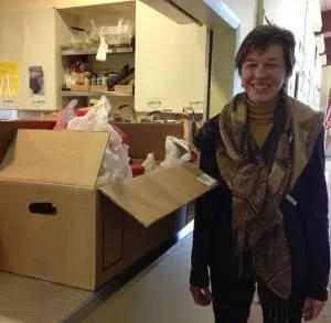 Noreen Fee, treasurer of the PTA, stands with food donations collected at the elementary school winter concert at Haldane.photo csimek