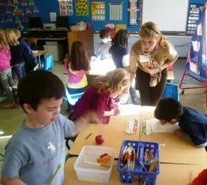 Garrison School Board Member Theresa Orlandi helps students during Mad Science Week 2012.
