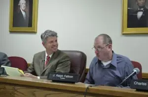 Outgoing Mayor Seth Gallagher, left, and mayoral candidate Trustee Ralph Falloon react to Chuck Hustis' comment that working with the mayor has been 'entertaining.' Photo by J. Tao