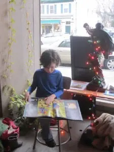 An engrossed young reader finds a good reading spot at the PARP launch. Photo by A. Rooney