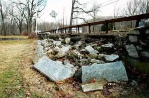 A stretch of wall tumbles into the yard at St. Philip's church. Photo by L.S. Armstrong