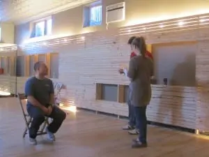 Chris Edwards watches Laurence Berkowitz and Rachel Ashendorf rehearse a scene.
