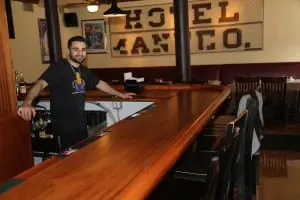 Owner Frank Ciafardini behind the newly refurbished bar at Whistling Willie's American Grill. Photo by Maggie Benmour