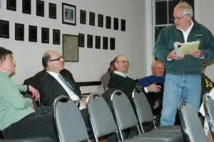 At the Town Board meeting, GVFC members Betsy Calhoun, far left, and Steve Rosario, left, confront Joe Regele, far right, a long-time critic of GVFC financial management. Photo by L.S. Armstrong