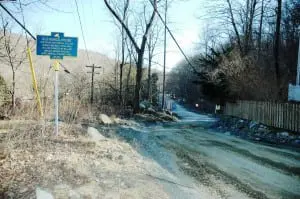 A historical marker, near the site of an old schoolhouse, stands along the section of Old Albany Post Road scheduled for paving.