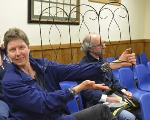 Sue Peehl holds up a section of fencing she proposes to go around tree beds on Main Street, which could cost $500-1,000, depending on the number of beds to be fenced. Photo by J. Tao