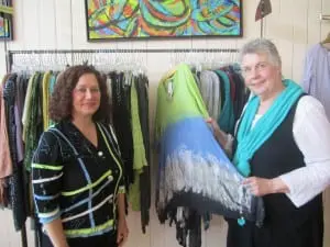 Barbara Galazzo, left, and Marilyn Heberling, with potential artwork from Art to Wear Too. Photo by A. Rooney