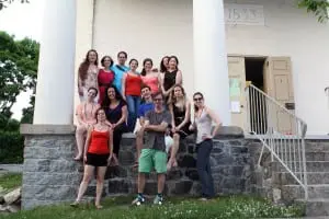 Students and staff of When the Heart Sings pose in front of the Chapel Restoration, where their performances will take place. (Photo by Jose Alvarez)