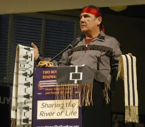 Jake Edwards of the Onondaga Nation Council of Chiefs holding the Canandaigua Treaty Belt and the Two Row Wampum Belt.