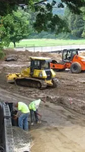 Construction crew members work on the Haldane sports field.