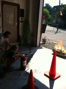 Kyle Irish, Dept. Chief at Garrison Volunteer Fire Co., instructs students in the highly technical skill of extinguishing fires.