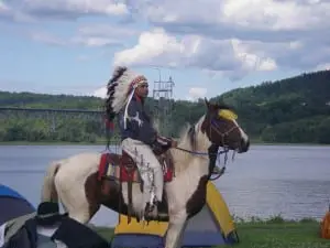 A Unity Rider makes his way on horseback through the paddling crew's campsite.