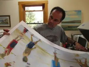 Joe Diebboll takes an Iris print by Rob Diebboll off of the printer.   Photo by Lisa Diebboll