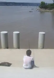 Oliver, age 8, keeps a watchful eye on his fishing line.