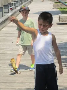 Jean Paul is proud but uncertain about his catfish catch.