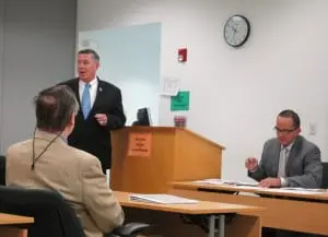 Flanked by Constitution Island Association Executive Director Richard de Koster, back to camera, and hearing officer Robert Martinez, right, Sheriff Donald Smith addresses the hearing. Photo by L.S. Armstrong