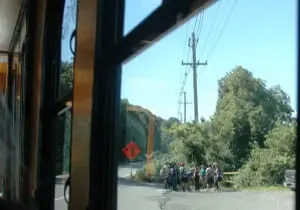 Viewed from the trolley, hikers prepare to set off from a Breakneck trail parking area. 