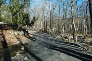 Excess water on Upland Drive, a private dirt road near Old Albany Post Road, has added to concerns about upkeep over time. A proposed town law would demand that subdivision developers address road maintenance in advance. Photo by L.S. Armstrong