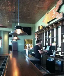 A directional sign from the old Mt. Beacon ski resort hangs over the bar. Hudson Beach Glass designed and produced the lights.