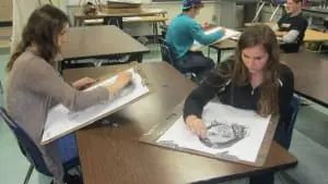 StudentsâKellyâVahos,âleft,âandâShaunaâRickettsâareâengrossedâinâworkingâonâtheirâdrawingsâofâeachâother.â
