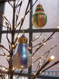 Maureen Winzig presents her hand-painted light bulb decorations.