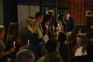 Students hold symbolic candles at the induction ceremony.  (Photo courtesy of Damian McDonald)
