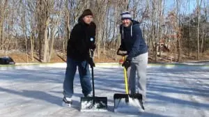Joel Conybear, right, chair of the Philipstown Winter Carnival, and John Maasik, chair of the Philipstown Recreation Commission, donned their skates to shovel the ice at the new outdoor skating rink at the Claudio Marzollo Community Center in Garrison. (Photo by M. Turton)