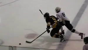 Ice Time: Garrison School eighth grader Alex Mancuso, No. 84 for the Junior Black Knights bantam hockey team, battles for the puck against Trinity-Pawling Feb. 15 at Tate Rink. The JBK team tied with Trinity-Pawling 4-4. Mancuso led his team with two goals to a 4-2 victory over Trinity-Pawling Feb. 16 at Pawling. (Photo by Mary Ann Ebner)