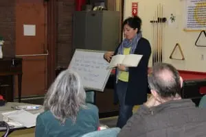 Kathy Curto, standing, displays an example of how a journal can be used. 