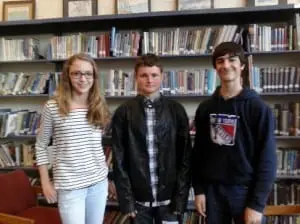 Garrison Middle School students Alii Sharpley, left, and Alex Mancuso, right, welcome guest speaker Durant Crow, center, a student at James I. O'Neill High School.