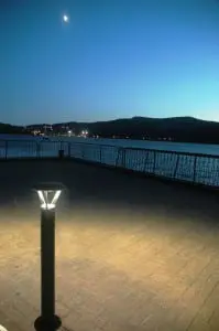 A partial moon hangs above the Hudson River at the Cold Spring dock, with the lights of West Point in the background across the river. (Photo by L.S. Armstrong)