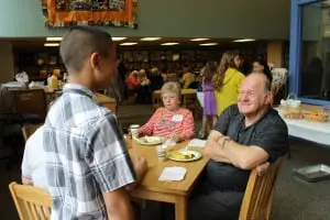 Terry Ridpath regales a sixth grader with tales of the school in the late 50s and early 60s.