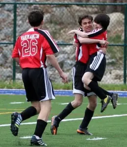The U-15 Philipstown Daggers' Jeremy Roffman lifts younger brother Justin Roffman in celebration of Justin's first-ever team goal in Sunday's 5-3 win against the Poughkeepsie Fire. (Photo by Scott Warren)