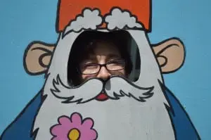 Caryn Cannova peeks through a gnome cut-out in Kismet's Secret Garden.