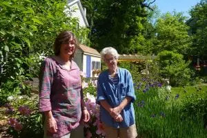 From left, Deborah Little and Rebecca Sperling have created a lovely outdoor space in their yard in the village, full of flowers, fruit trees and vegetables. (Photo by P. Doan)