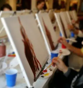 Multiple painters at work on their tabletop easels. (Image courtesy of eat-Paint-love)