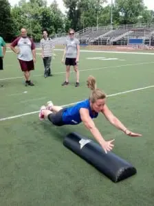 Kristin Noschese Van Tassel, player safety coach for Philipstown Hawks, performs the SHOOT drill at the Heads Up Football Clinic. (Photo provided)