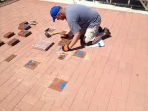 Dan Hughes, past president of the Blue Devil Booster Club, lays the first Walk of Fame personalized bricks at Brigati Field, Cold Spring, Aug. 24.