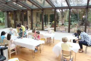This room, with extensive windows, functions as both an art space and a lunch area.