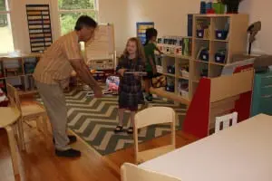 First grade teacher Adam Osterfeld confers with a student, who takes it under consideration!