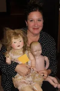 Lisa Scheffer with two of her scary dolls