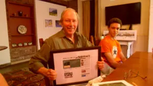 Stewart receiving a framed memento of the website Philipstown.info