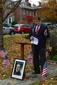 Roger Keppel, commander of VFW Post 2362, told the story of James Harvey Hustis, for whom the post is named and whose photo is at the base of the podium.