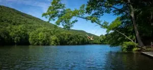A photo of Jay Pearsall swinging over Lake Valhalla serves as the cover of the new Hudson Highlands Land Trust book (photo by Christine Ashburn)